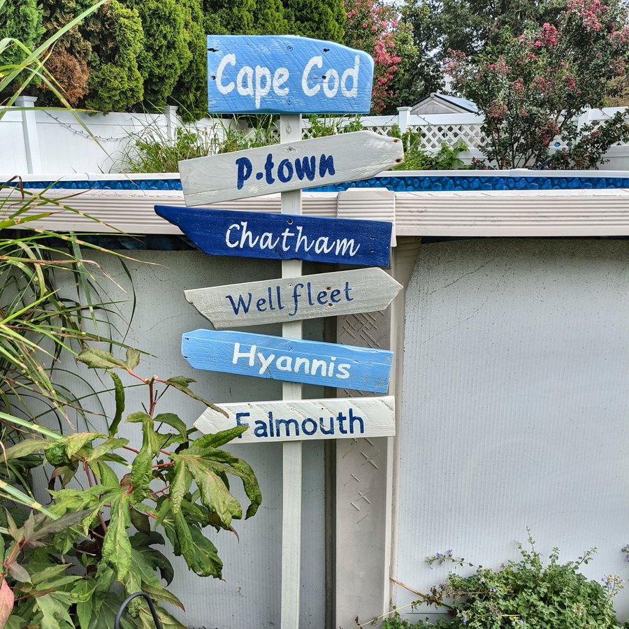A Cape Cod sign beside a shingled house