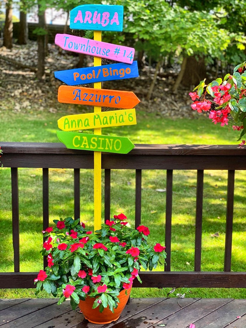 A custom directional sign reading Townhouse #14, Pool/Bingo, Azzurro, Anna Maria's and Casino