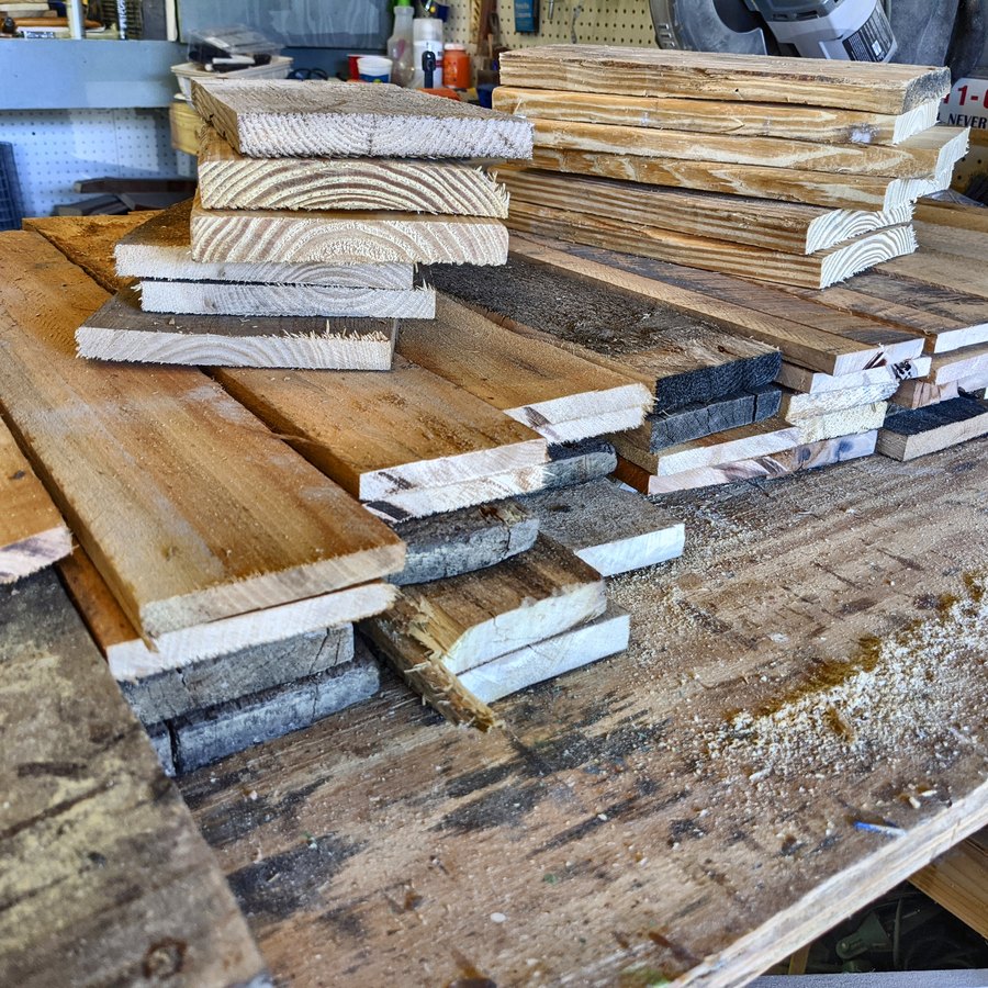 Reclaimed boards planed and cut into arrow blanks