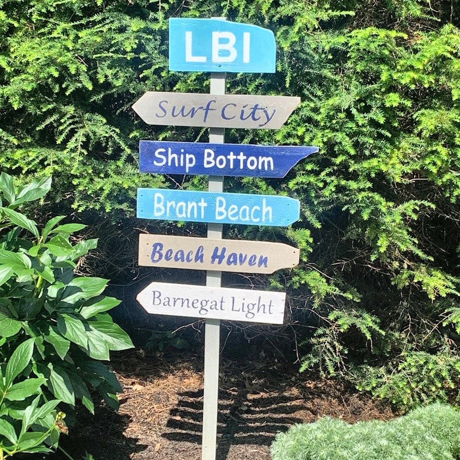 An LBI sign in a garden beside a house
