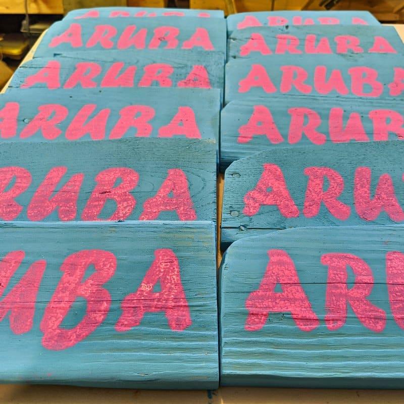 Freshly painted Aruba top signs stacked in the shop